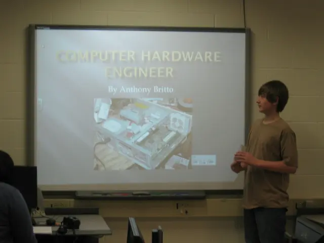 In the image there is a boy in brown t-shirt standing in front of screen, on the left side there is...