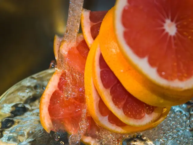 There are slices of orange. Below that there is water with bubbles.