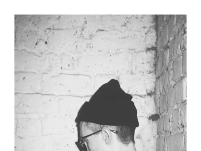 In the picture I can see a person wearing black T-shirt is having spectacles to his eyes and a hat...